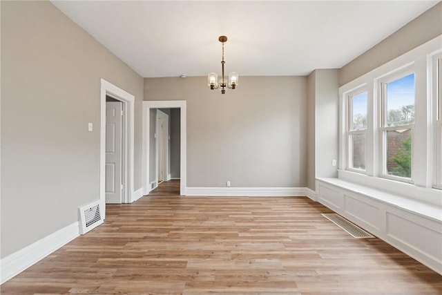 410 Butz St, New Castle/3Rd, PA 16101 - unfurnished dining area featuring baseboards, a chandelier, visible vents, and light wood-type flooring
