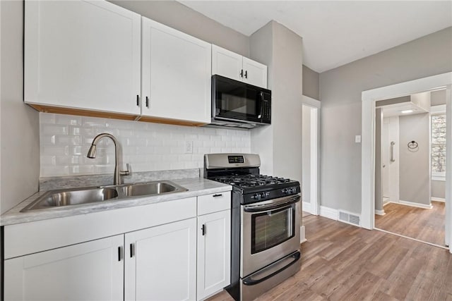 410 Butz St, New Castle/3Rd, PA 16101 - kitchen with black microwave, a sink, stainless steel gas range oven, light countertops, and visible vents