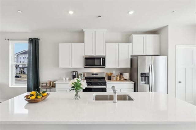 177 Sweetwater Dr, Moon/Crescent Twp, PA 15108 - kitchen featuring an island with sink, light countertops, white cabinets, a sink, and appliances with stainless steel finishes