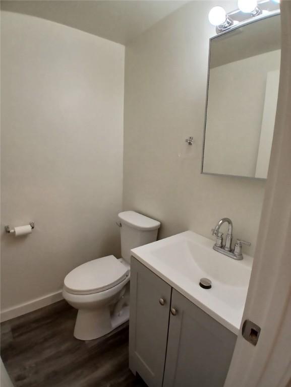 2318 Salisbury St, South Side, PA 15210 - bathroom featuring vanity, toilet, and wood finished floors