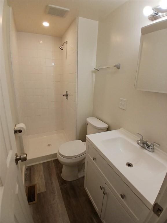 2318 Salisbury St, South Side, PA 15210 - full bath featuring a tile shower, toilet, wood finished floors, and visible vents