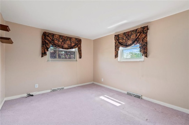spare room with baseboards and visible vents