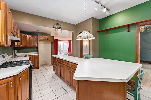 503 Beechwood Ave, Carnegie, PA 15106 - kitchen featuring track lighting, brown cabinetry, gas range oven, a sink, and light tile patterned floors