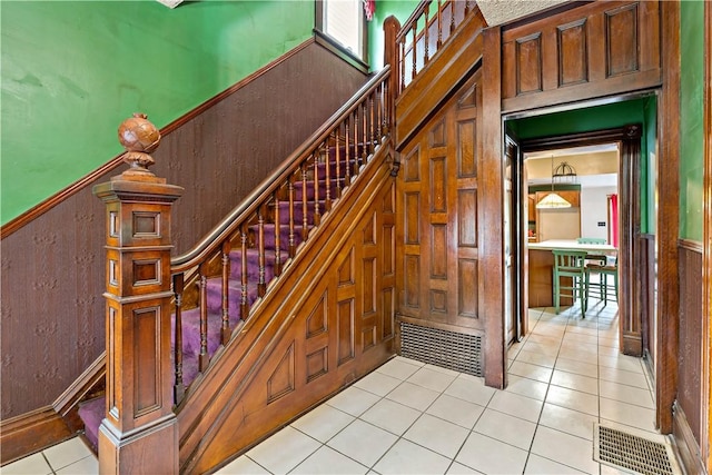 503 Beechwood Ave, Carnegie, PA 15106 - stairway with wood walls, wainscoting, and tile patterned flooring