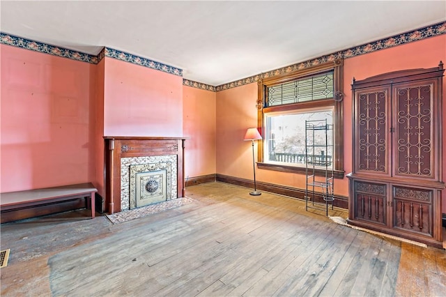 503 Beechwood Ave, Carnegie, PA 15106 - unfurnished living room with baseboards, a fireplace with flush hearth, and hardwood / wood-style flooring