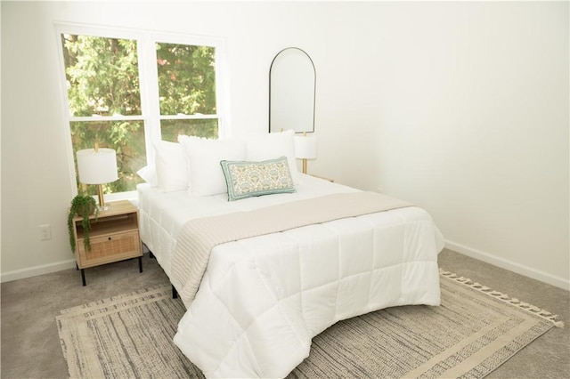 bedroom featuring carpet flooring and baseboards