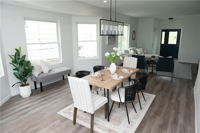 dining area with recessed lighting, baseboards, and wood finished floors