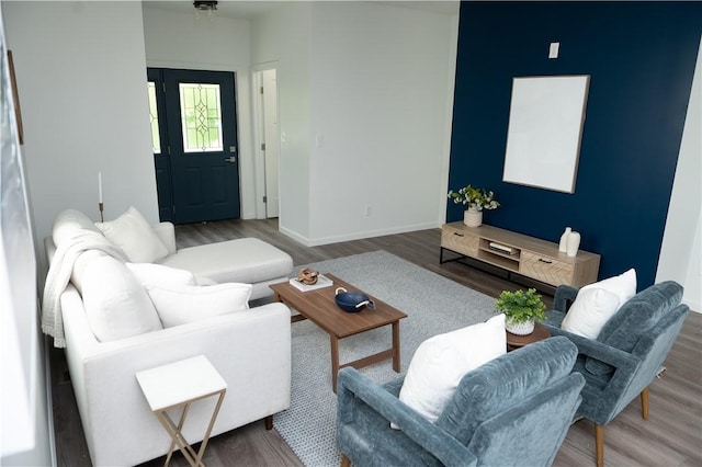 living room with baseboards and wood finished floors
