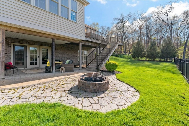 view of yard featuring french doors, a fire pit, stairway, and a patio area