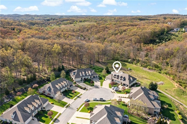 bird's eye view with a residential view and a wooded view