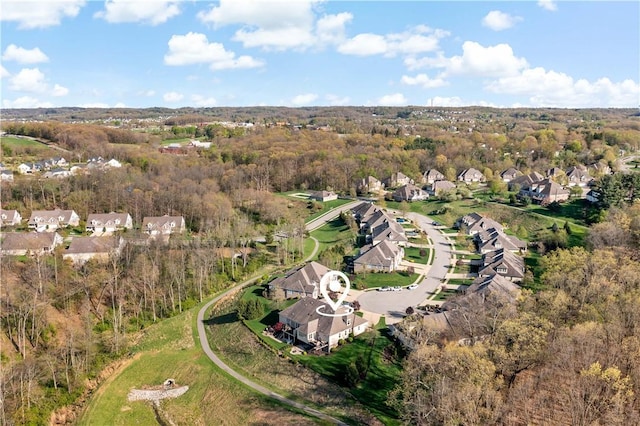 aerial view featuring a residential view and a wooded view