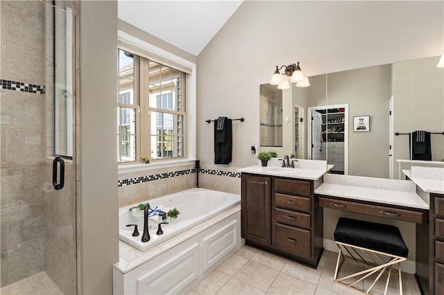 bathroom with vanity, a garden tub, lofted ceiling, and a stall shower