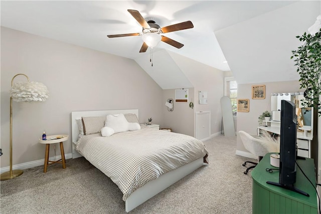bedroom featuring a ceiling fan, baseboards, vaulted ceiling, and light carpet