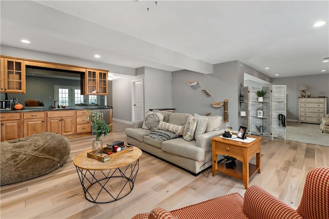 living area with recessed lighting, baseboards, and light wood finished floors