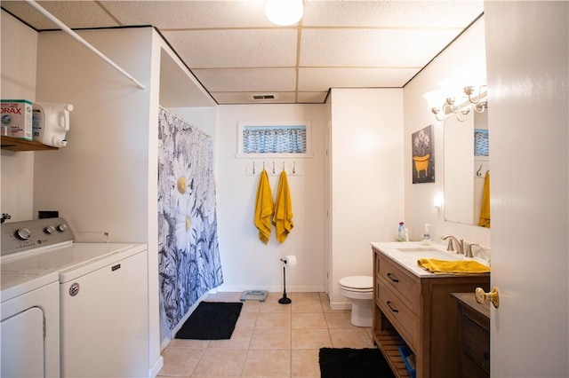 357 Pohls Rd, Raccoon Twp, PA 15001 - bathroom featuring tile patterned flooring, baseboards, toilet, separate washer and dryer, and a drop ceiling