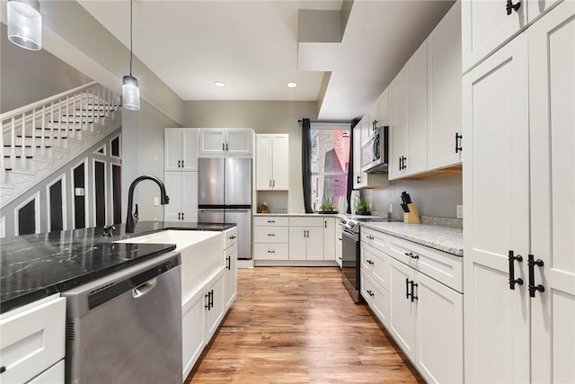 308 Jacksonia St, Central North Side, PA 15212 - kitchen with a sink, appliances with stainless steel finishes, white cabinetry, and decorative light fixtures