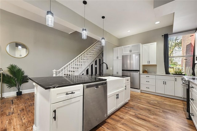 308 Jacksonia St, Central North Side, PA 15212 - kitchen featuring light wood-style floors, pendant lighting, white cabinetry, and stainless steel appliances
