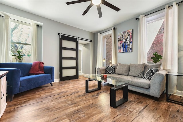 308 Jacksonia St, Central North Side, PA 15212 - living room featuring baseboards, ceiling fan, light wood-type flooring, and a barn door