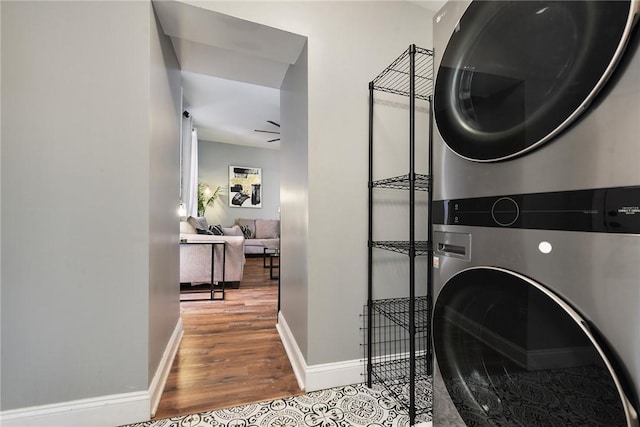 308 Jacksonia St, Central North Side, PA 15212 - clothes washing area with baseboards, stacked washer / drying machine, wood finished floors, and laundry area