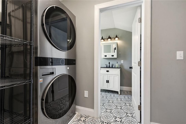 308 Jacksonia St, Central North Side, PA 15212 - laundry room with baseboards, stacked washer and clothes dryer, a sink, and light tile patterned floors