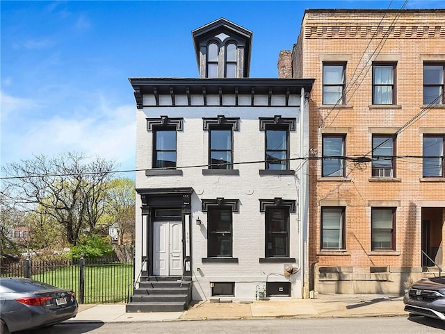 308 Jacksonia St, Central North Side, PA 15212 - view of front facade with brick siding, fence, and entry steps