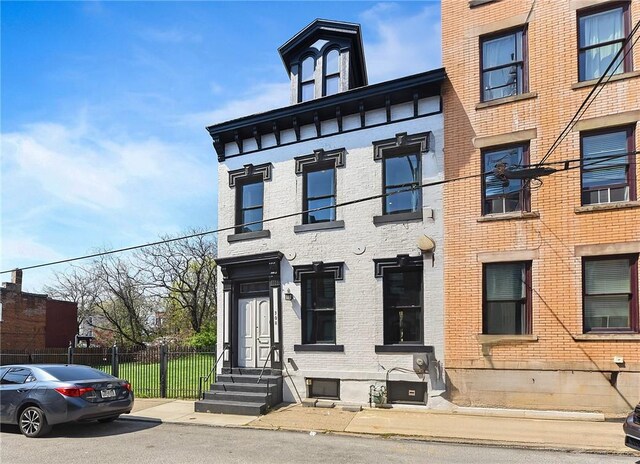 308 Jacksonia St, Central North Side, PA 15212 - view of front facade with brick siding, fence, and entry steps