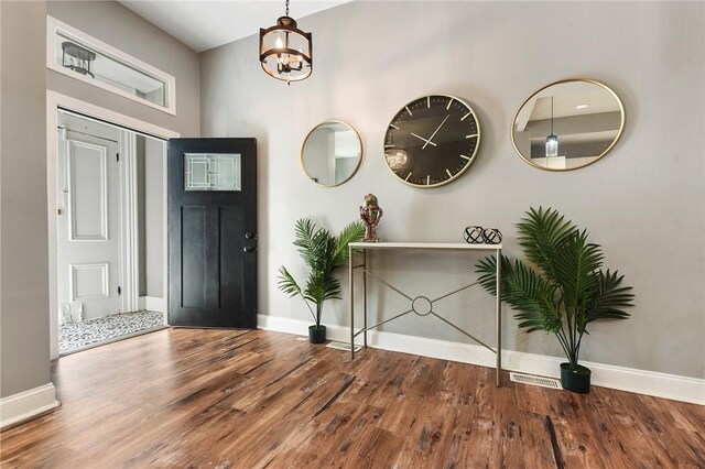 308 Jacksonia St, Central North Side, PA 15212 - foyer with baseboards, a notable chandelier, and wood finished floors