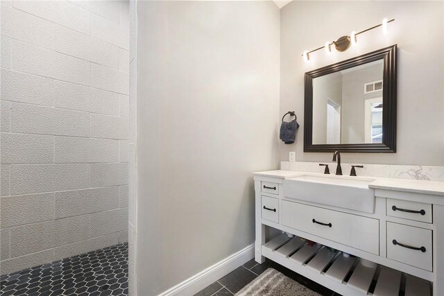 308 Jacksonia St, Central North Side, PA 15212 - full bathroom with a tile shower, tile patterned flooring, vanity, baseboards, and visible vents