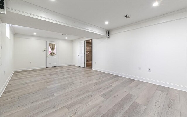 finished basement featuring visible vents, recessed lighting, light wood-style flooring, and baseboards