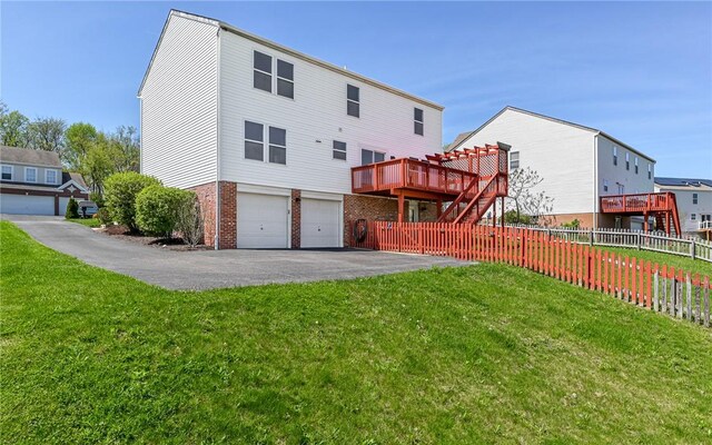 4929 Apple Ridge Dr, Hampton, PA 15101 - rear view of property featuring driveway, brick siding, an attached garage, a deck, and stairway