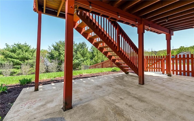 view of patio / terrace with fence and stairs
