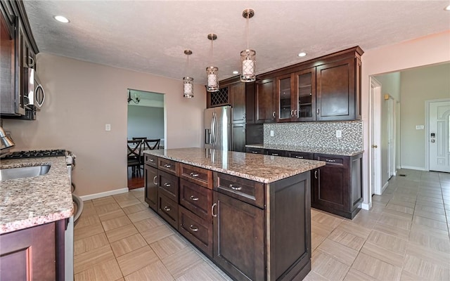 kitchen featuring decorative backsplash, dark brown cabinets, baseboards, recessed lighting, and appliances with stainless steel finishes