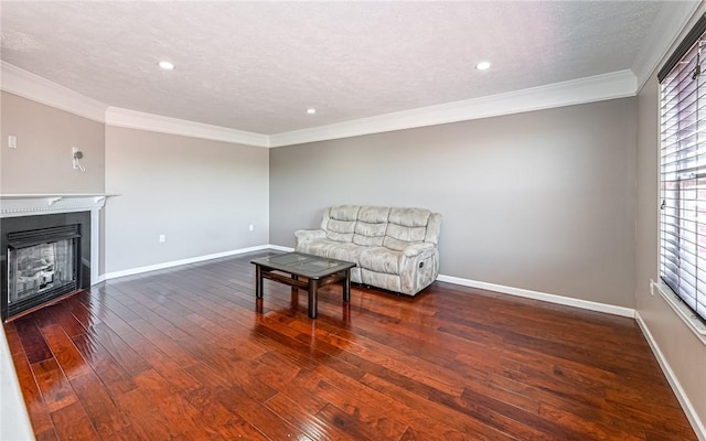 sitting room featuring wood-type flooring, ornamental molding, baseboards, and a fireplace