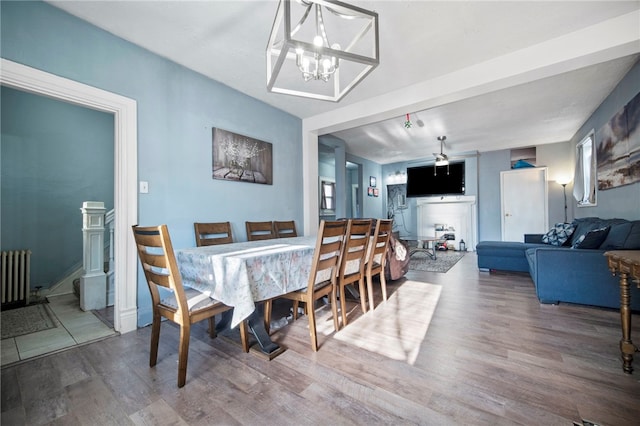 206 7th St, Oakmont, PA 15139 - dining space featuring wood finished floors, radiator, and a chandelier