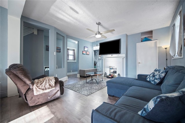 206 7th St, Oakmont, PA 15139 - living area featuring a textured ceiling, a ceiling fan, wood finished floors, and baseboards