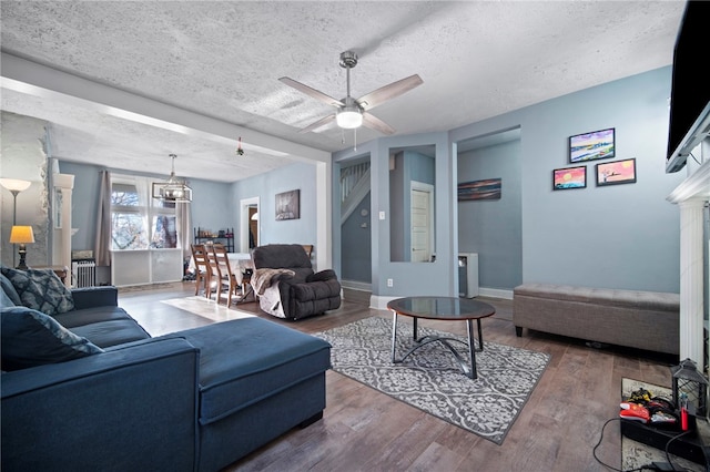 206 7th St, Oakmont, PA 15139 - living room with wood finished floors, ceiling fan, baseboards, a chandelier, and a textured ceiling