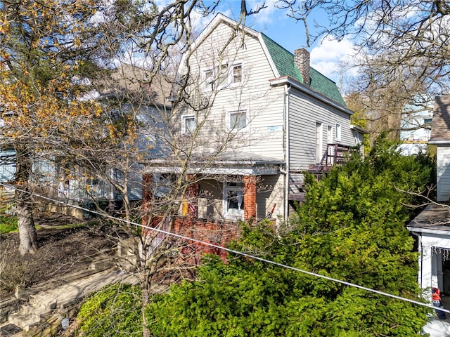 206 7th St, Oakmont, PA 15139 - view of property exterior with a chimney, brick siding, and roof with shingles
