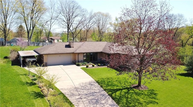 view of front facade with driveway, a chimney, a front yard, and a garage