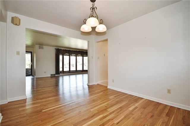 interior space with baseboards and light wood finished floors