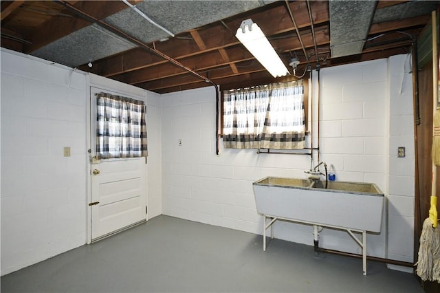 below grade area featuring a wealth of natural light and concrete block wall