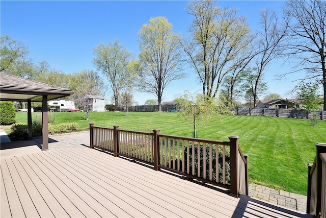 deck with a yard and fence