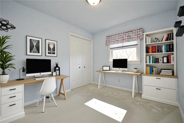 home office with baseboards and light colored carpet