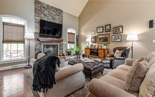 124 Field Brook Ln, Richland, PA 15044 - living room featuring a stone fireplace, a wealth of natural light, high vaulted ceiling, and hardwood / wood-style flooring