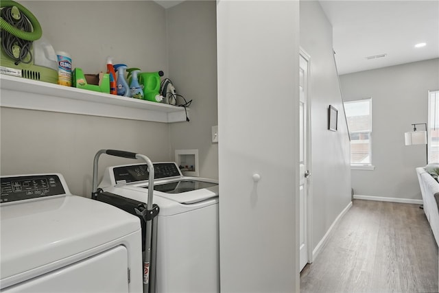 laundry room with visible vents, light wood-style flooring, independent washer and dryer, and laundry area