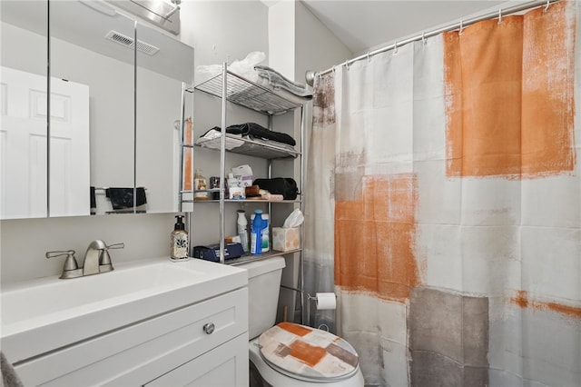 bathroom featuring visible vents, curtained shower, toilet, and vanity