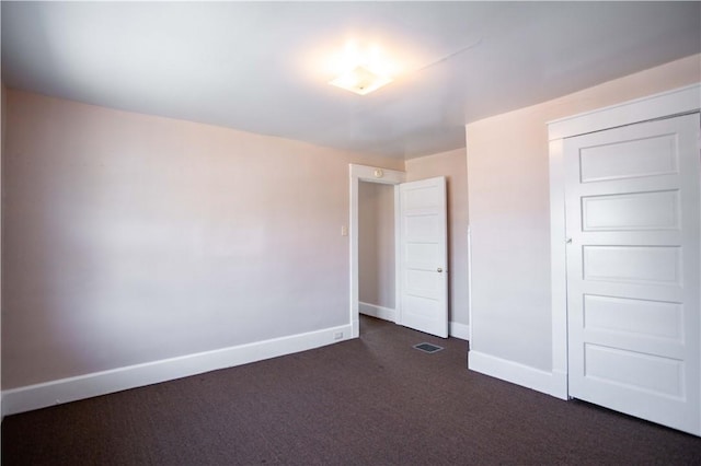 1315 Main St, Aliquippa, PA 15001 - unfurnished bedroom featuring dark colored carpet, baseboards, visible vents, and a closet