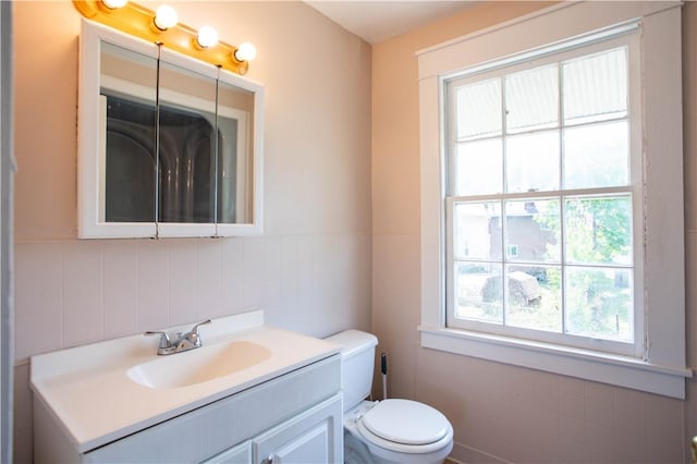 1315 Main St, Aliquippa, PA 15001 - bathroom with toilet, tile walls, a wainscoted wall, and vanity