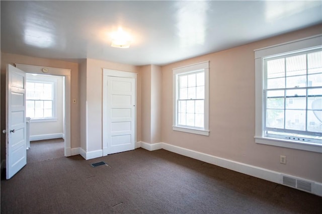 1315 Main St, Aliquippa, PA 15001 - unfurnished bedroom featuring baseboards, a closet, dark carpet, and visible vents