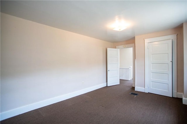 1315 Main St, Aliquippa, PA 15001 - unfurnished bedroom with baseboards, dark carpet, and visible vents