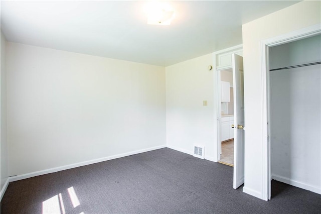 1315 Main St, Aliquippa, PA 15001 - unfurnished bedroom with baseboards, visible vents, dark carpet, and a closet